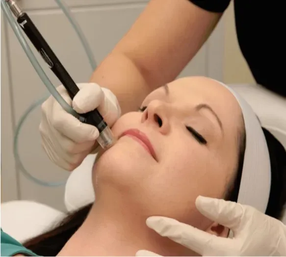 Facial treatment in progress with skincare device.