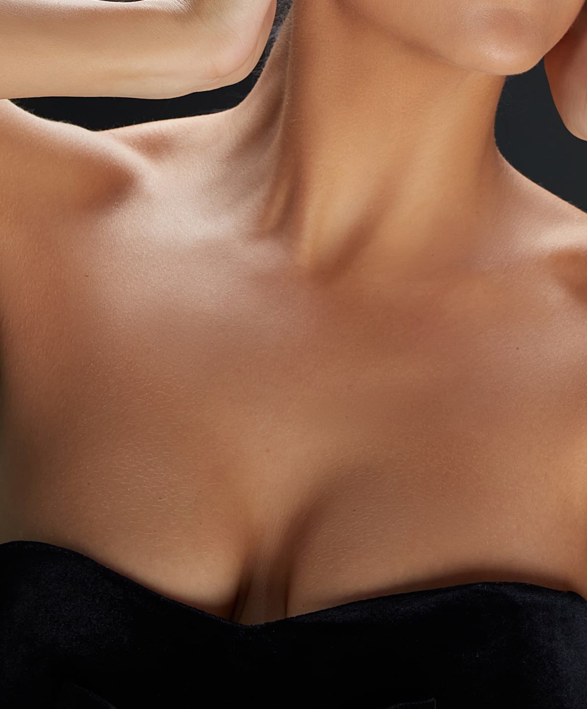 charlotte breast lift with implants model with hand near face