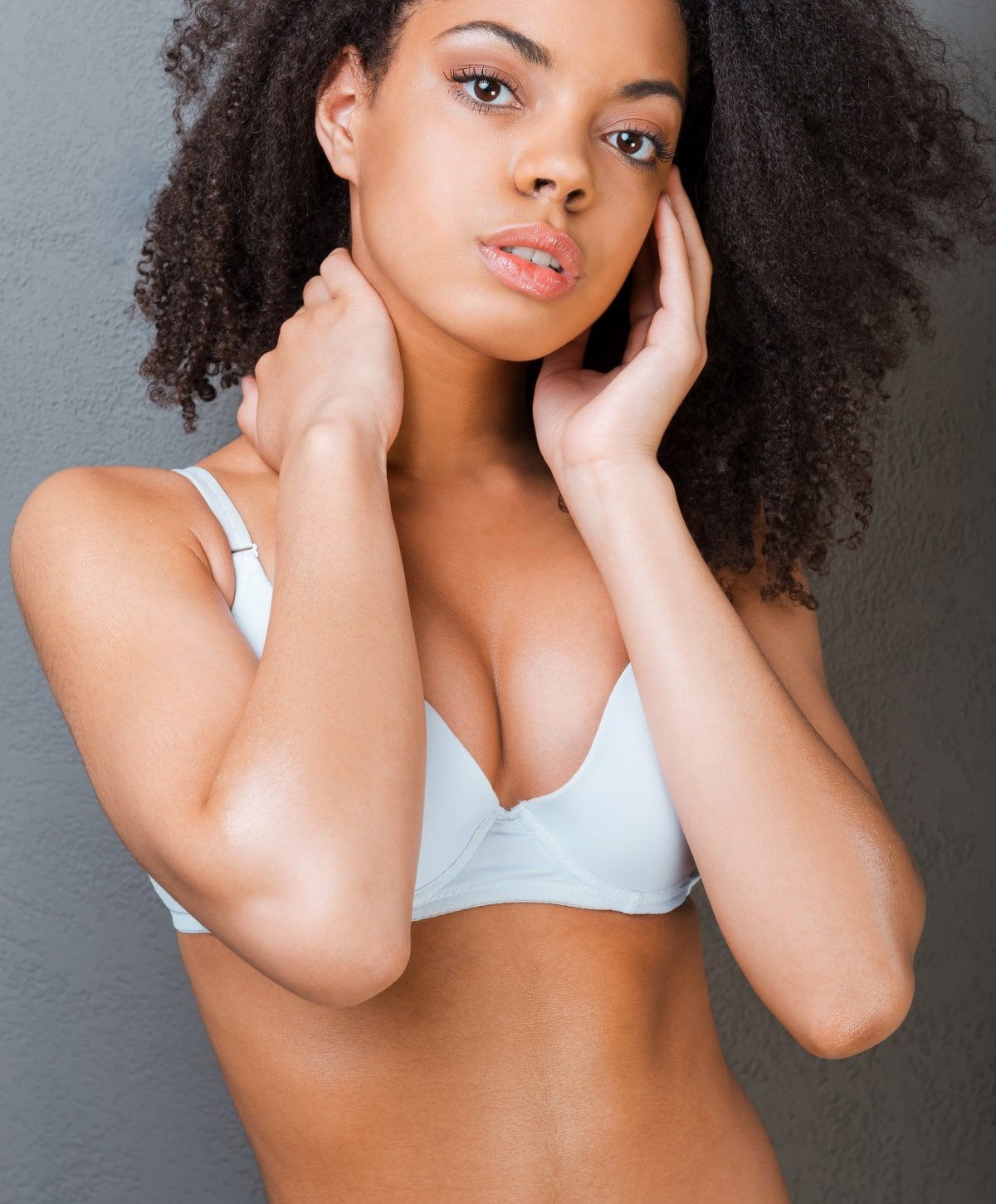charlotte breast lift with implants model with curly hair