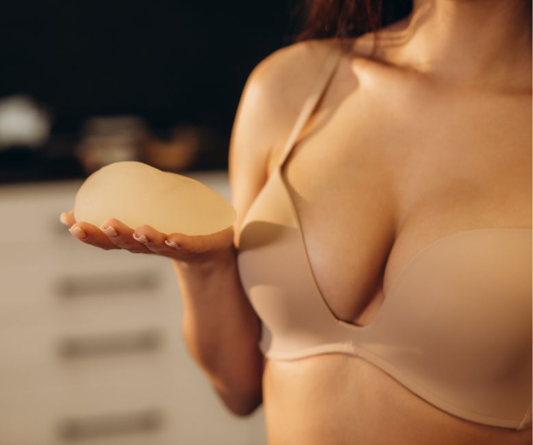 Charlotte Plastic Surgery model holding implant