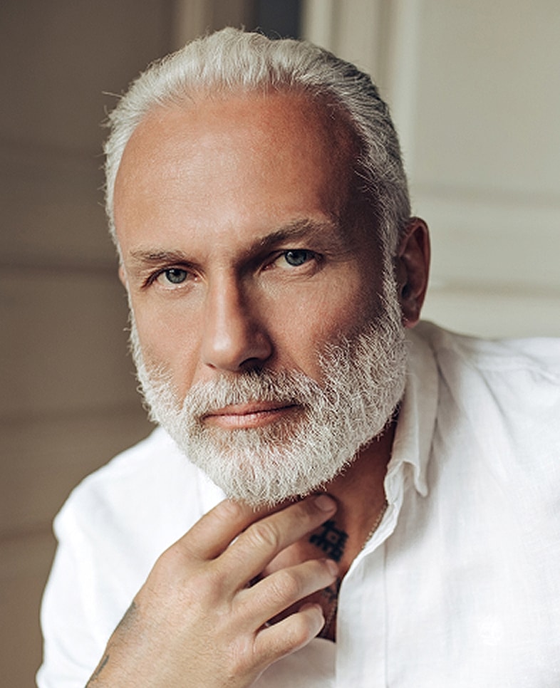 White patterned background with floral design elements.