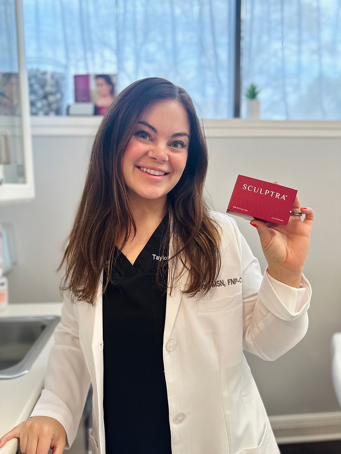 Professional holding Sculptra product in clinic.