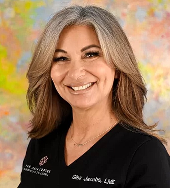 Smiling professional with long, wavy hair.