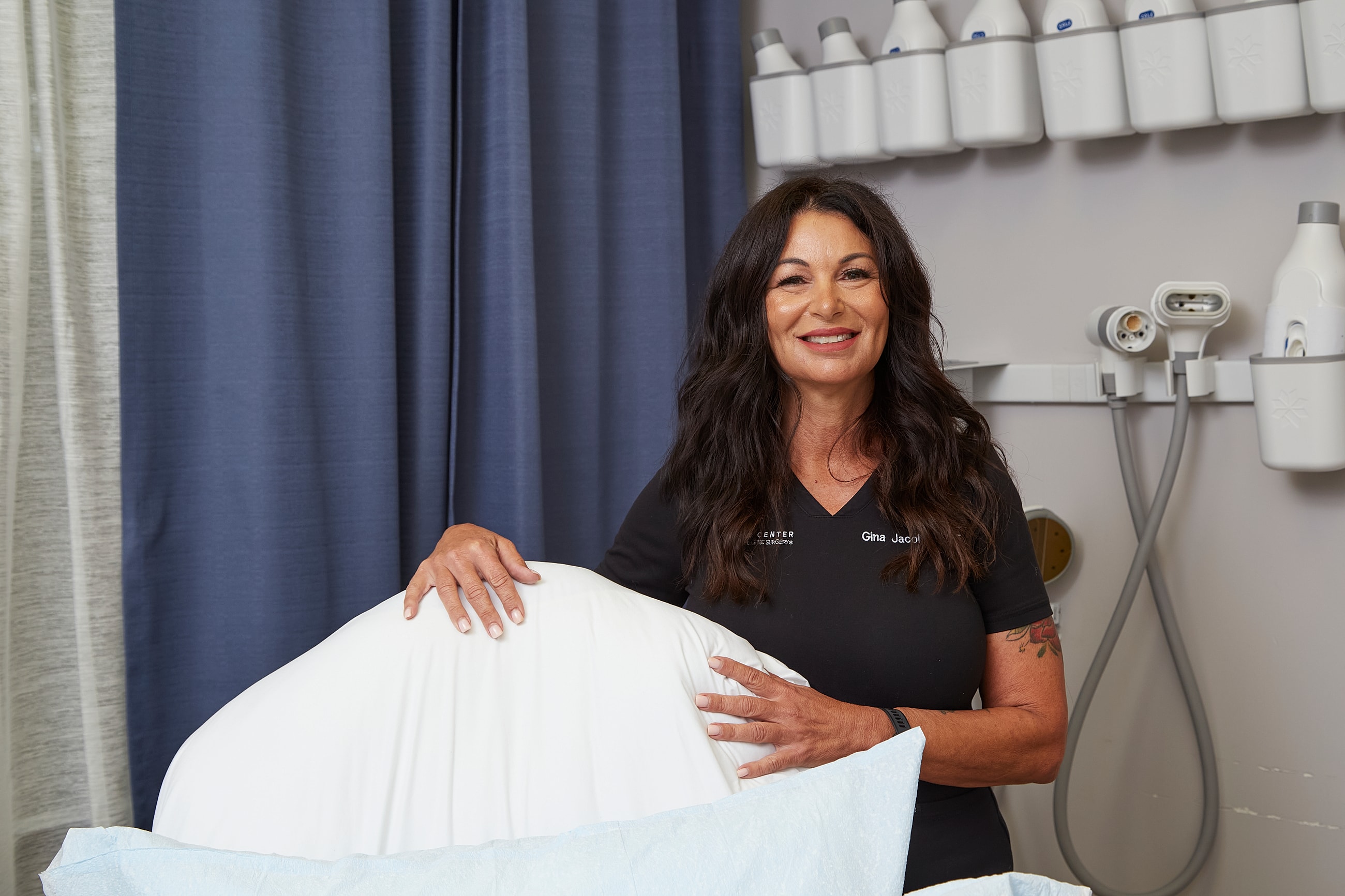 Spa professional with massage table setup.